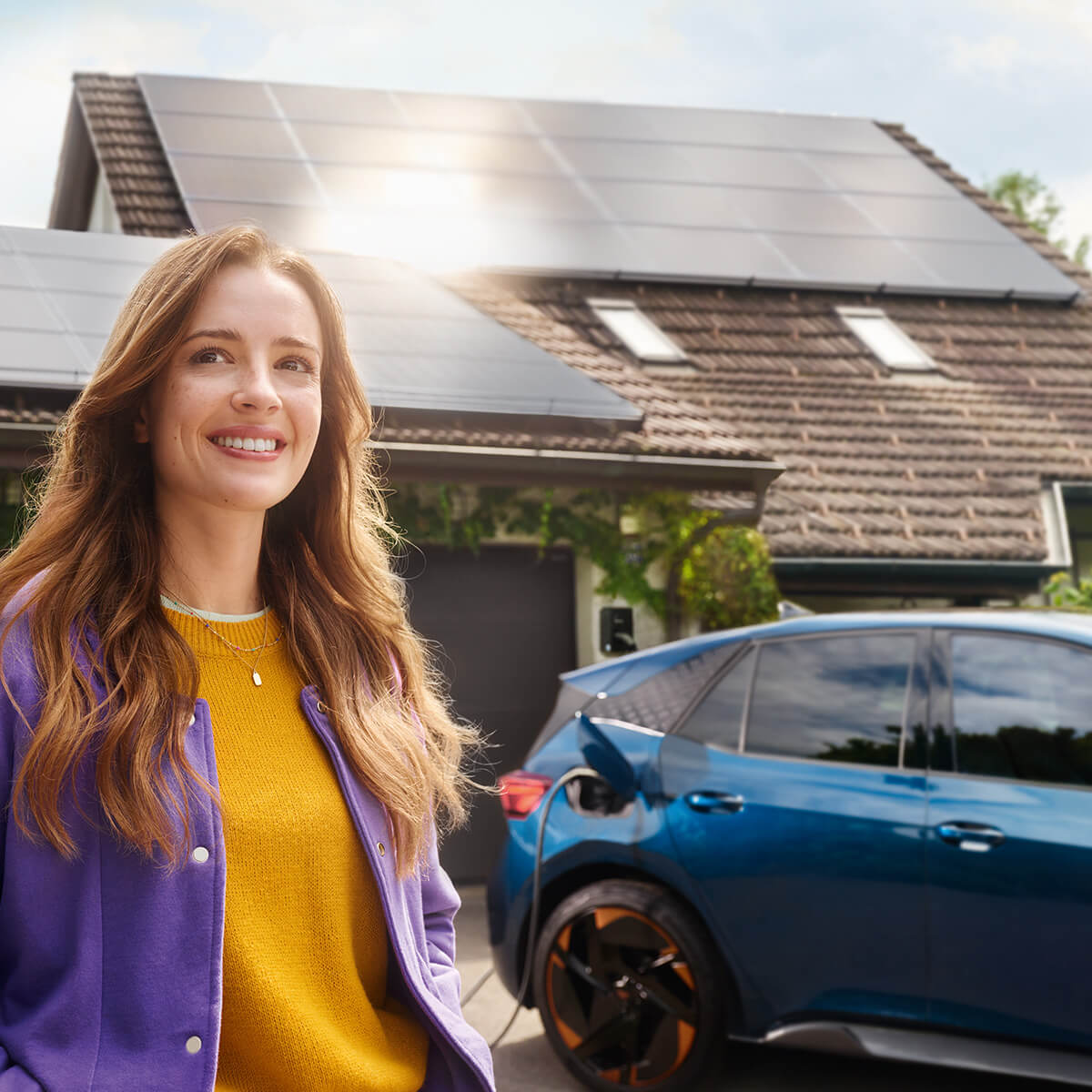 Young woman charges the CUPRA Born with solar energy